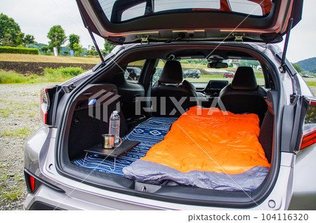 Sleeping in the car with a mat and sleeping bag 104116320