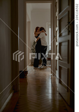 Romantic couple hugging and enjoying time together while standing at home. Good relationship time Romantic couple hugging and enjoying time together while standing at home. Good relationship time 104116502