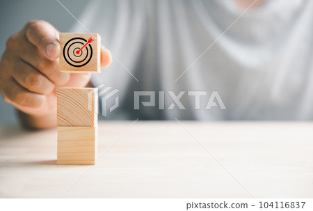 Wood block stacking arranged by a hand to symbolize a business strategy and Action plan. It signifies business development and emphasizes growth and success in the corporate world. Wood block stacking arranged by a hand to symbolize a business strategy and Action plan. It signifies business development and emphasizes growth and success in the corporate world. 104116837