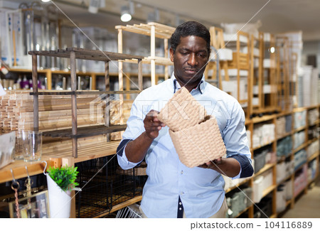 African american man choosing storage boxes in store African american man choosing storage boxes in store 104116889