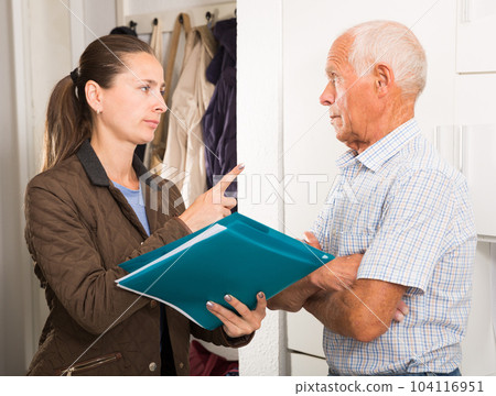 Businesswoman trying to collect arrearages from erderly man at home door 104116951