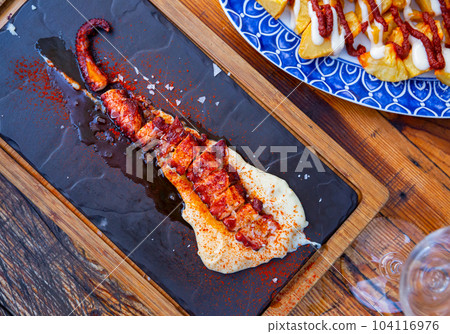 Ggrilled octopus tentacle with potato parmentier Ggrilled octopus tentacle with potato parmentier 104116976