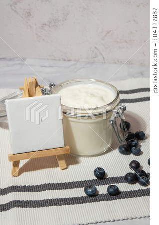 Glass jar with natural organic homemade yogurt and blueberries on table. Immunity-boosting ingredients Copy space empty note. Concept of healthy eating breakfast of Greek yogurt 104117832