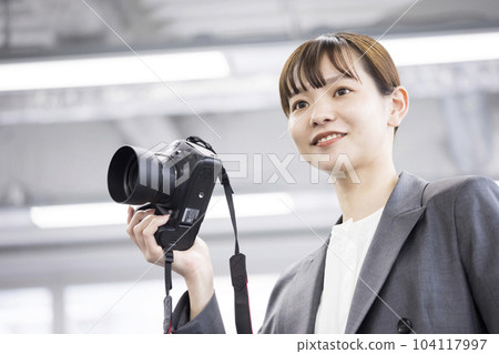 Female photographer shooting image Female photographer shooting image 104117997