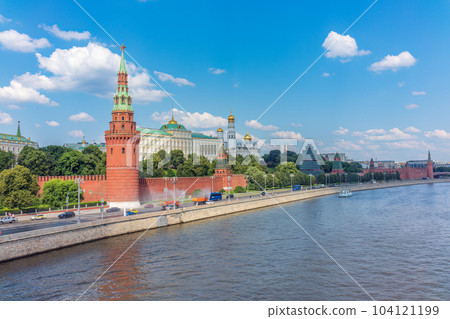 View of Kremlin with Vodovzvodnaya tower, Grand Kremlin Palace from repaired Bolshoy Kamenny Bridgein Moscow city on sunny summer day View of Kremlin with Vodovzvodnaya tower, Grand Kremlin Palace from repaired Bolshoy Kamenny Bridgein Moscow city on sunny summer day 104121199
