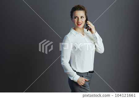 happy business owner woman talking on phone and looking aside happy business owner woman talking on phone and looking aside 104121661