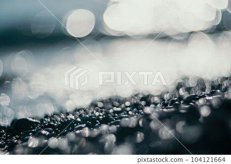 Abstract nature summer ocean sunset sea background. Small waves on water surface in motion blur with bokeh lights from sunrise. Holiday, vacation and recreational background concept. 104121664