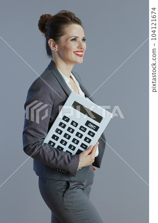 happy 40 years old business woman isolated on grey 104121674