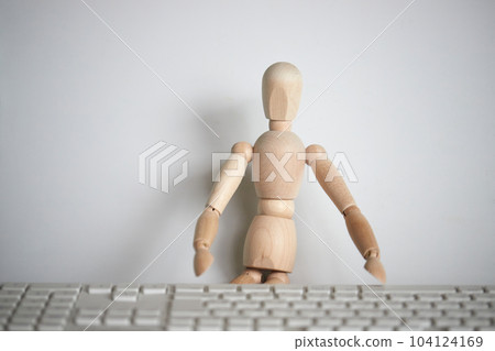 wooden mannequin and computer keyboard wooden mannequin and computer keyboard 104124169