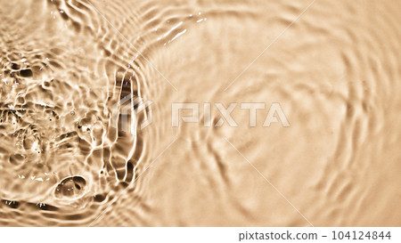 Beige water surface background. Water texture with splashes and bubbles for design. Summer background. Background for cosmetics design. 104124844