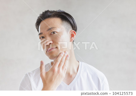 Man shaving with an electric shaver 104125573