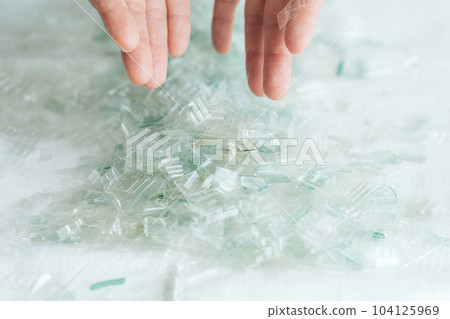 Hand photo with a piece of plastic 104125969