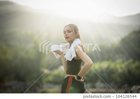 Healthy Asian woman is jogging outdoor. Fitness girl running. Female exercising at outdoor park 104126544