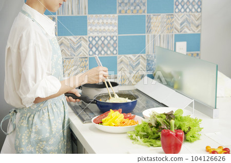 Woman stir-frying vegetables Faceless 104126626