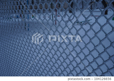 Frosted wire fence in winter Frosted wire fence in winter 104126656