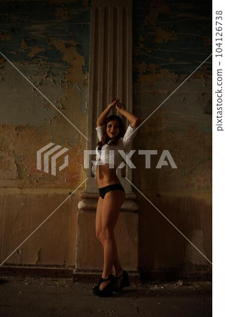 The woman on ladder in an old building. 104126738