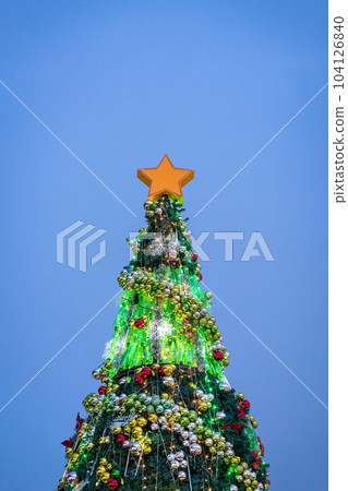Beautifully decorated Christmas tree lighted up. 104126840