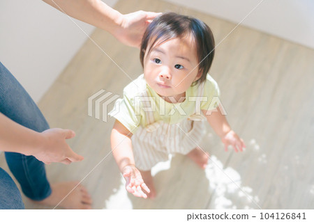 Baby's Standing Practice Mom's Support 104126841