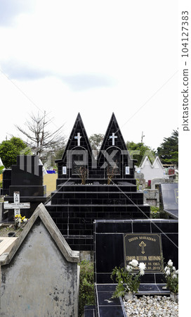 Public cemetery with varied graves. Public cemetery with varied graves. 104127383