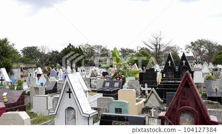 Public cemetery with varied graves. 104127384