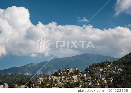 View of the abandoned city next to Kayakoy. Karmilissos abandoned ghost town in Fethiye - Turkey, ruins of stone houses. Site of the ancient Greek city View of the abandoned city next to Kayakoy. Karmilissos abandoned ghost town in Fethiye - Turkey, ruins of stone houses. Site of the ancient Greek city 104128266