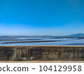 Breakwaters and tidal flats leading to the horizon 104129958