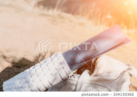 Woman summer travel sea. Happy tourist in hat enjoy taking picture outdoors for memories. Woman traveler posing on the beach at sea surrounded by volcanic mountains, sharing travel adventure journey 104130368