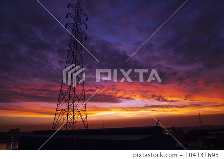 High voltage power line tower with beautiful sky at sunset, stock photo 104131693