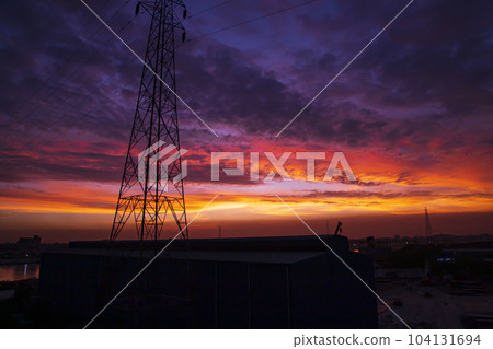 High voltage power line tower with beautiful sky at sunset, stock photo 104131694
