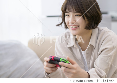 young woman playing video games 104131762