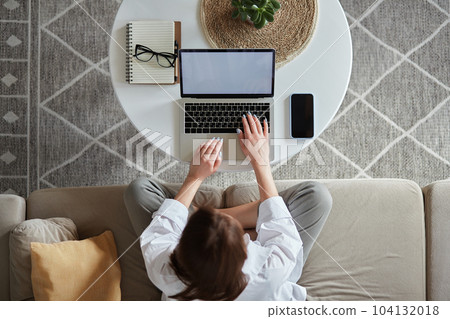 Mockup white screen laptop woman using computer sitting on sofa at home, top view Mockup white screen laptop woman using computer sitting on sofa at home, top view 104132018
