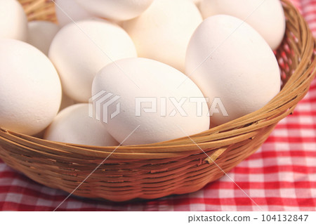 Basket of Farm Fresh Eggs on Red and White Checkered Fabric 104132847
