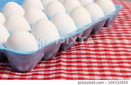 Carton of Eggs on Rustic Table With Checkered Table Cloth Carton of Eggs on Rustic Table With Checkered Table Cloth 104132850