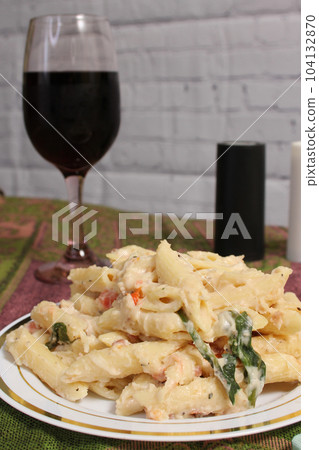 Plate of Pasta Carbonara With Italian Flat Bread on Rustic Table 104132870