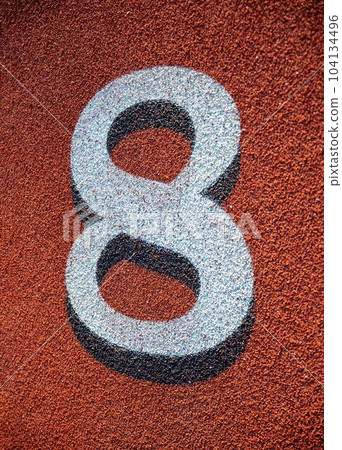 White number eight on red athletic track background White number eight on red athletic track background 104134496