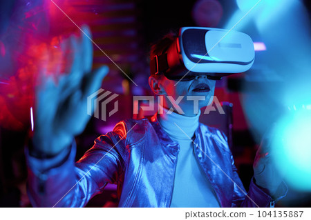 trendy 40 years old woman exploring metaverse in office 104135887