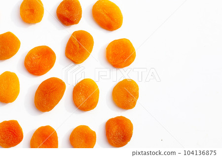 Dried apricots on white background. 104136875