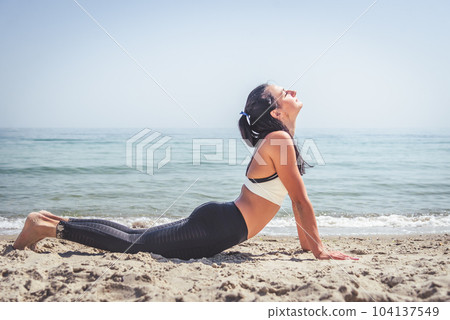 Fitness Girl working out on the beach 104137549