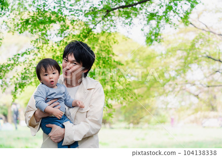 A baby boy who goes out for a walk with his father during maternity leave 104138338