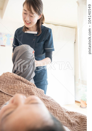 Chiropractor massaging a young woman 104140549
