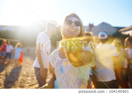 Group of friends have fun, dance at holi festival. Friendship, Leisure, Vacation, Togetherness. 104140901