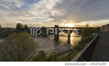 Pavia covered bridge over Ticino river at beautiful sunset Pavia covered bridge over Ticino river at beautiful sunset 104141293