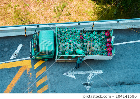 A view from above of a truck filled with gas bottles. Delivery of gas cylinders 104141590