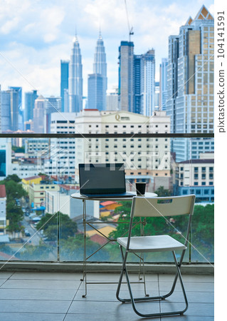 Ideal workspace on a high-rise balcony with a landscape view of the city center 104141591