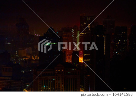 A nighttime cityscape. Night time illumination of a big city panorama. Top view from the drone. 104141593