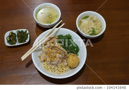 Mie Ayam or Chicken Noodle served in a bowl with meatballs in a restaurant in Semarang, Indonesia. Mie Ayam or Chicken Noodle served in a bowl with meatballs in a restaurant in Semarang, Indonesia. 104141648