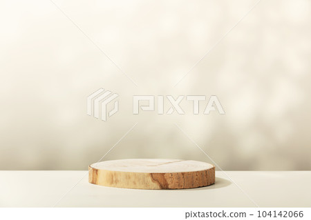 Wood slice podium with leaves shadows on beige background for cosmetic product mockup Wood slice podium with leaves shadows on beige background for cosmetic product mockup 104142066