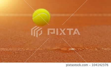 Freeze motion of flying tennis ball in court. 104142376