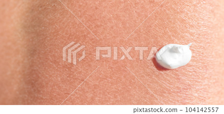 Close up of Sunscreen Protection or Sun Cream on human skin. Skin and Body Care. SPF Lotion or Moisturizing Sunblock to protect skin from the sun UV Sun screen cosmetic cream texture skincare product 104142557