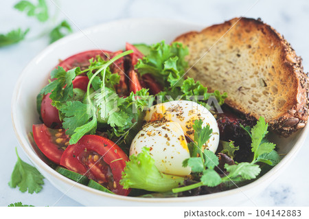 Vegetable salad with egg and whole grain toast for breakfast, white background. Vegetable salad with egg and whole grain toast for breakfast, white background. 104142883